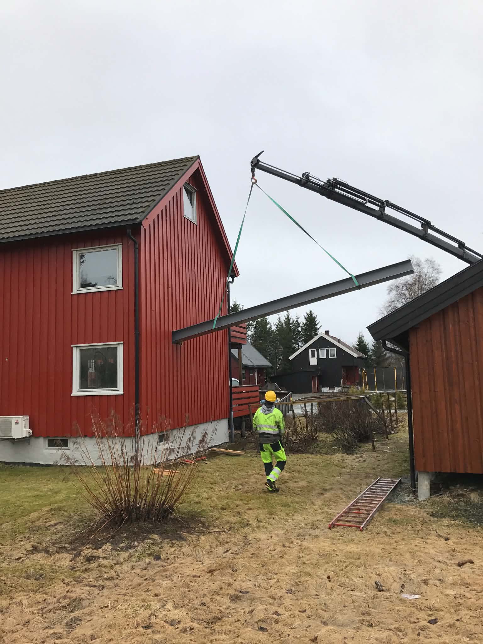 Løft av stålbjelke med kran på byggeplass